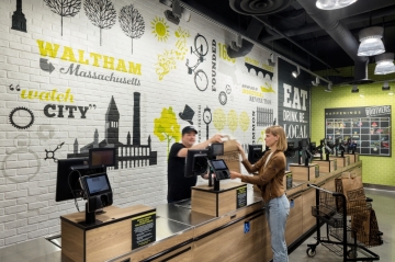 Brothers Marketplace Waltham Wins at the 2019 design:retail Spectrum Awards Brothers Marketplace Waltham Wins at the 2019 design:retail Spectrum Awards (image: woman checks out at store)